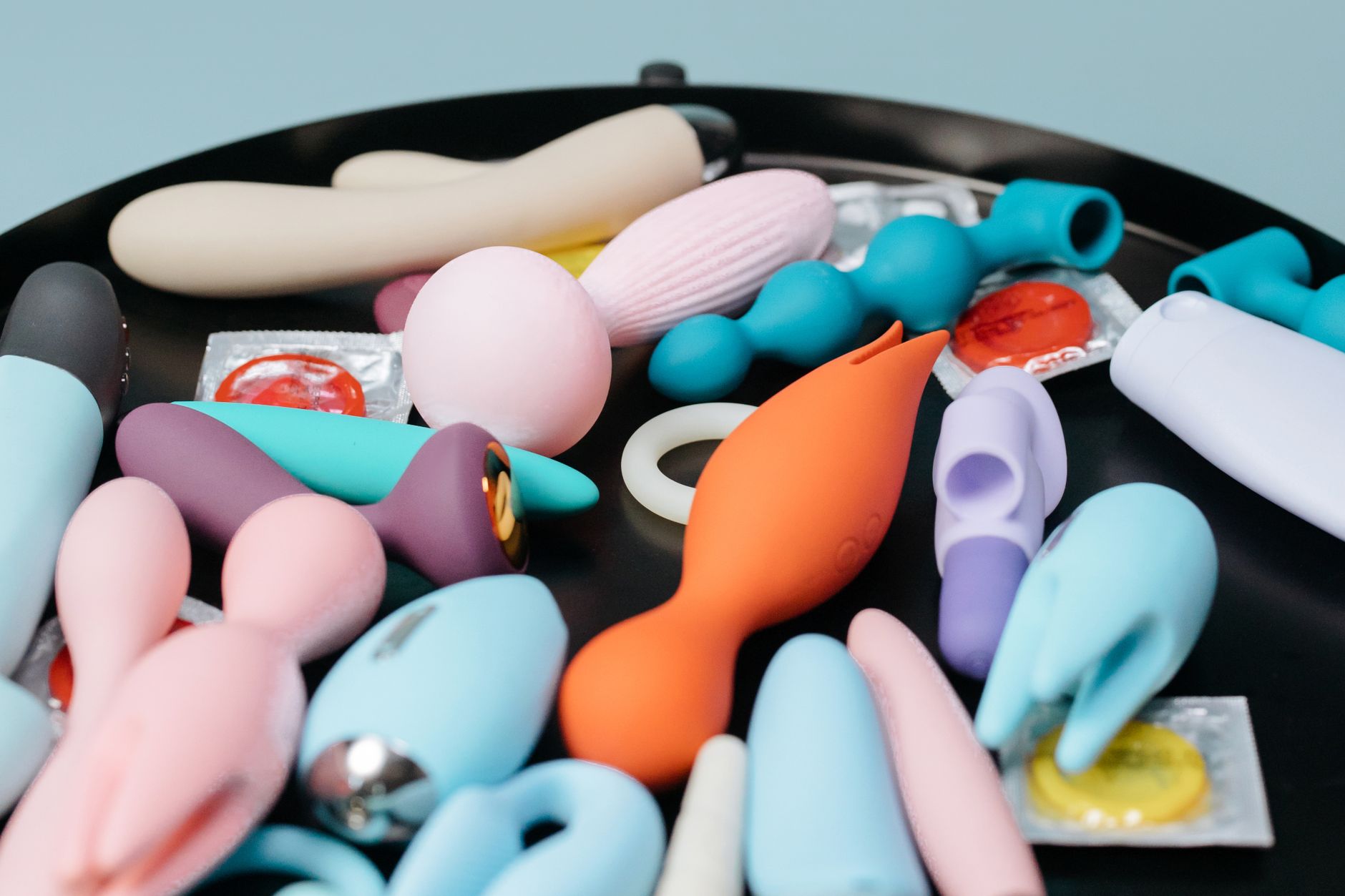 A vibrant collection of clitoral vibrators on display, featuring diverse shapes and colors