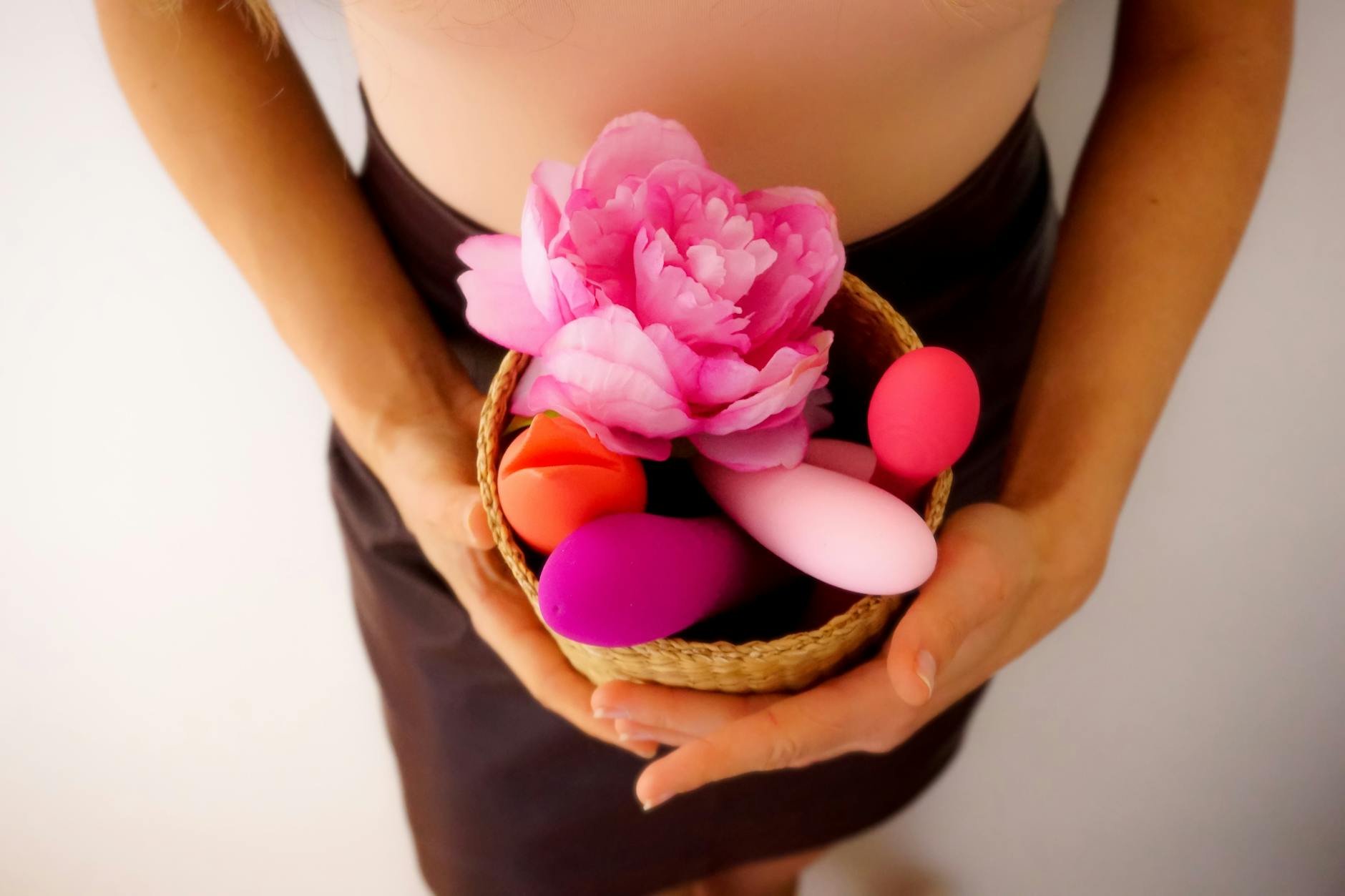 A basket of colorful vibrators and intimate wellness items displayed together